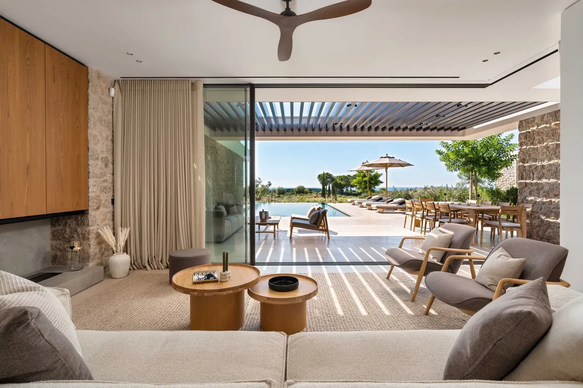 Living room opening onto the shaded terrace and private pool